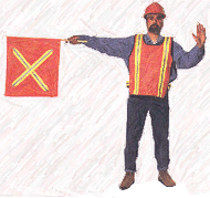 Un employé de chantier barrant la route avec un drapeau